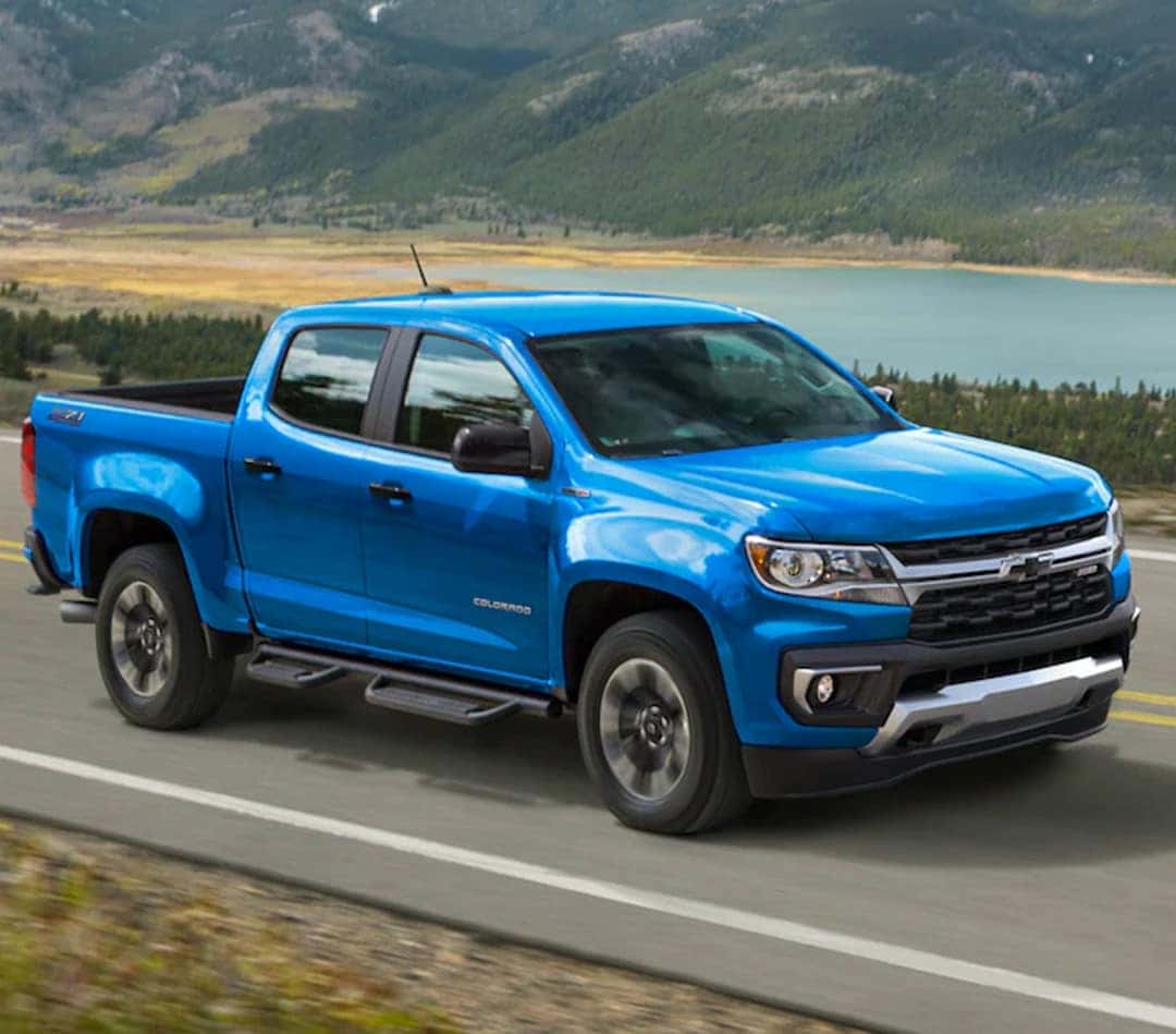 Blue Chevy Colorado near a lake