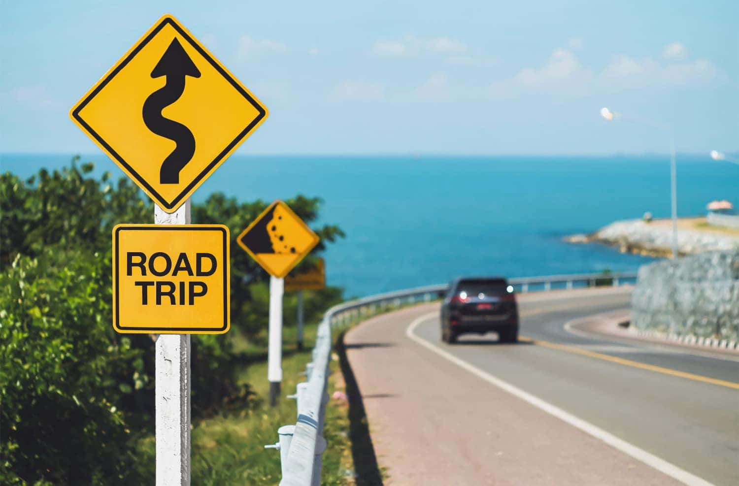 road trip sign with a scenic view on the background