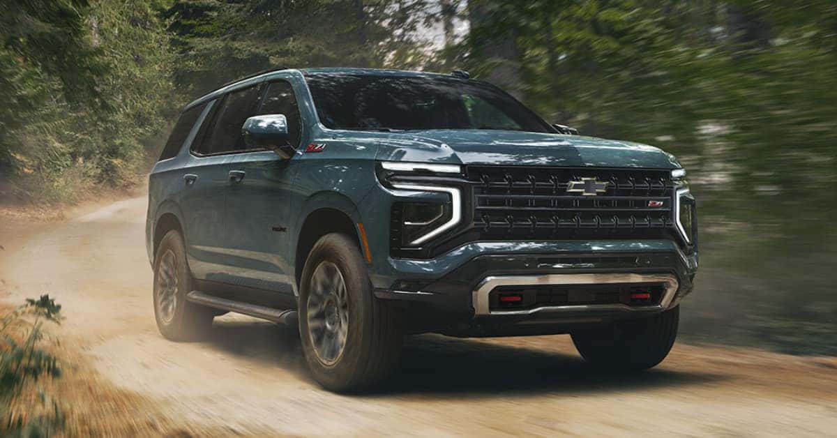 2025 Chevrolet Tahoe driving through a wooded path