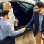 a-couple-making-a-deal-with-a-car-salesman