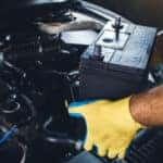 a-technician-replacing-the-battery-of-a-car