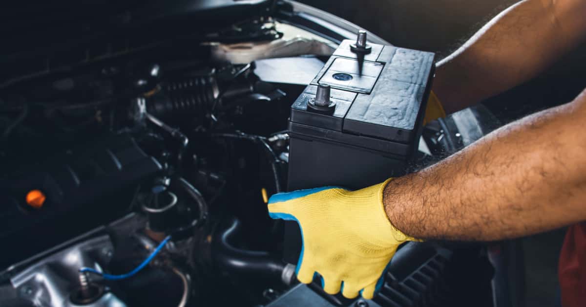 a-technician-replacing-the-battery-of-a-car