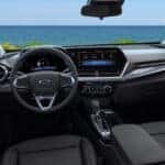 The interior of a 2026 Chevy Trax showing the steering wheel and infotainment system