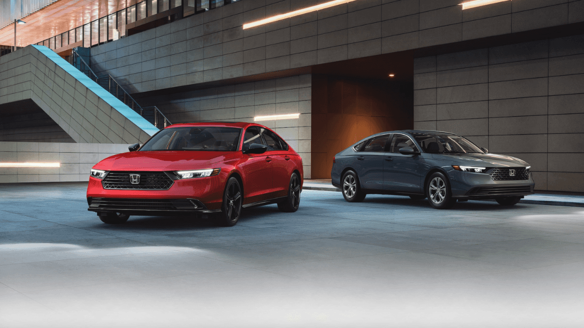Two Honda Accord models parked side by side outside a building