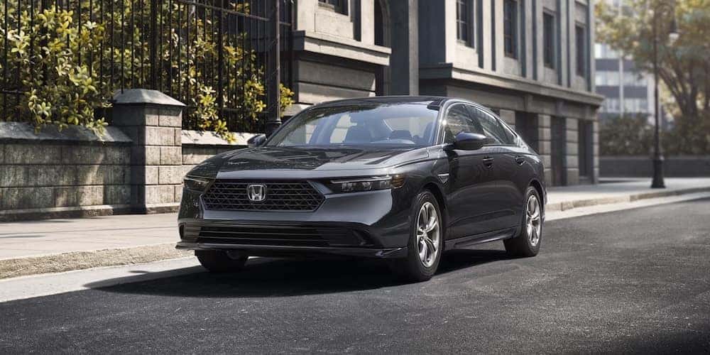 A gray 2026 Honda Accord sedan parked beside a stone wall