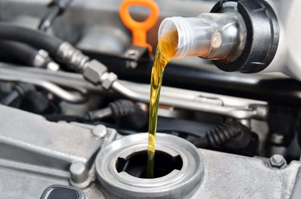 Motor oil being poured during auto service