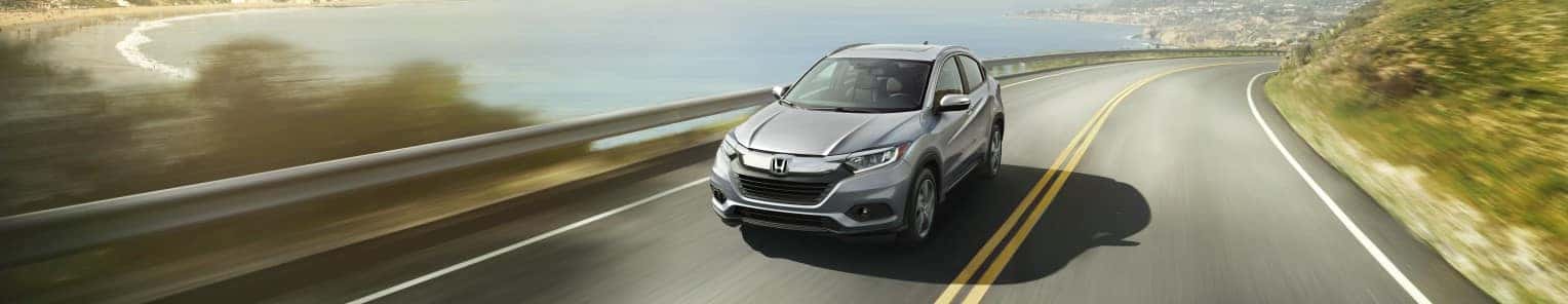2021 Honda HR-V silver driving on highway next to water