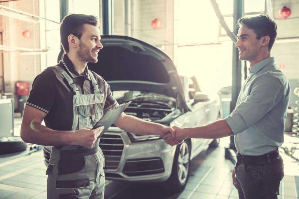 Technician Shaking Hands with Customer in Service Center