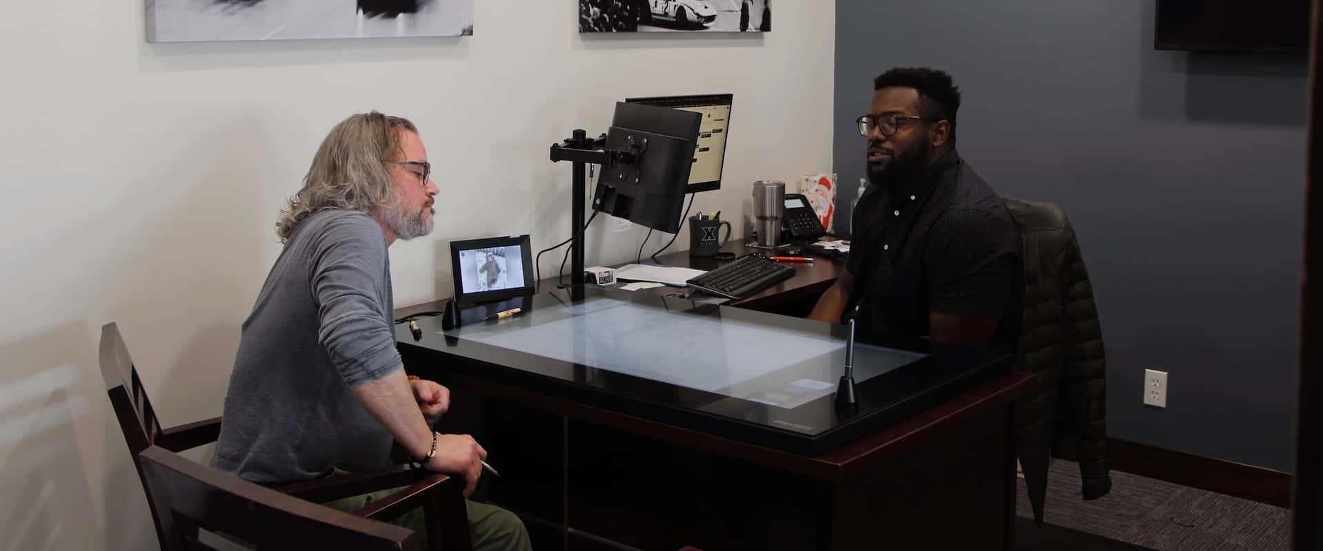a-finance-specialist-talking-to-a-couple-in-the-dealership