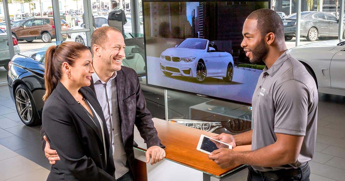 Sales rep talking with customers about BMW lease