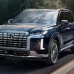 2024 Hyundai Palisade driving down a road