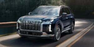 2024 Hyundai Palisade driving down a road