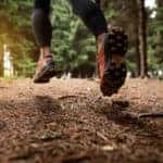close up of a person's shoes on a forest running trail
