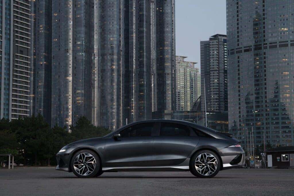 black hyundai ioniq 6 in front a city