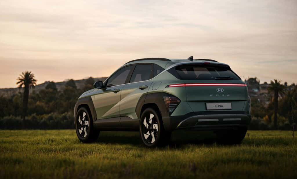 green hyundai suv parked in a field of grass