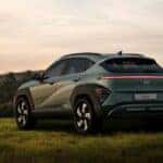 green hyundai suv parked in a field of grass