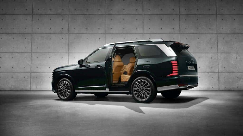 black hyundai palisade with doors open revealing a brown interior