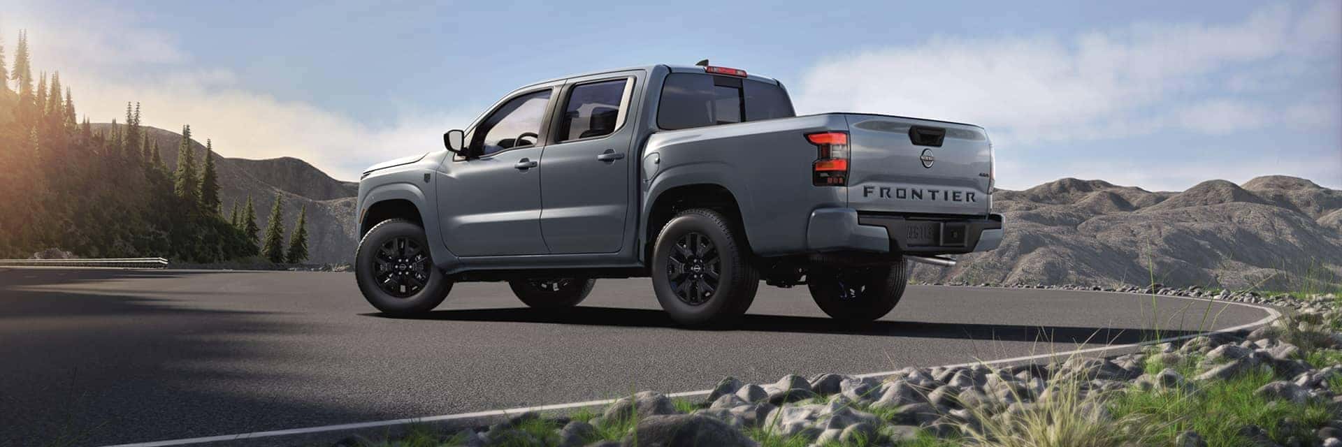 2025 nissan frontier parked in front of mountains