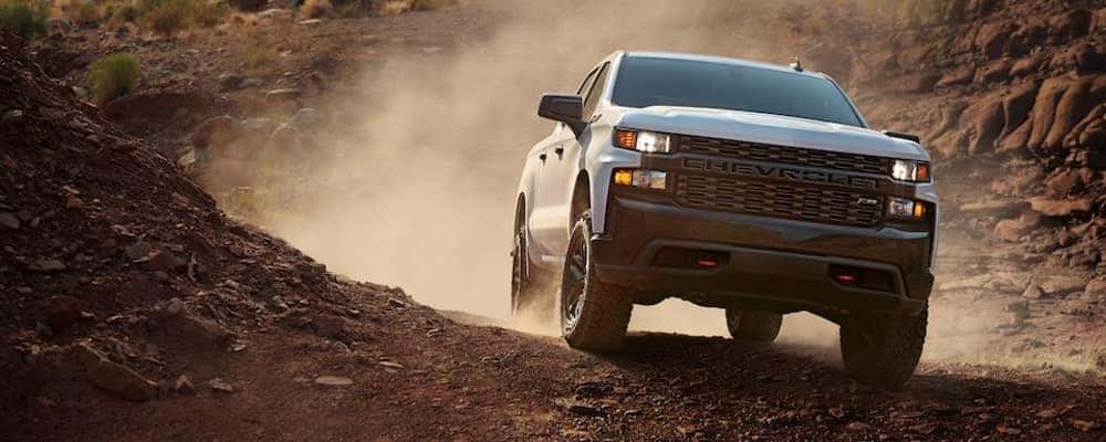 Chevy Silverado driving across rocky terrain