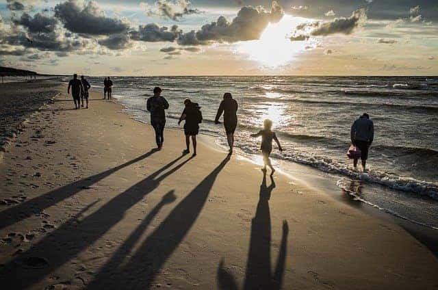 kids and parents walking on the beach