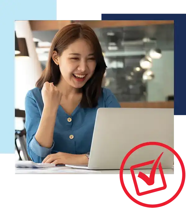 Fast and easy financing with Holiday Automotive - Woman pumping fist in success in front of laptop