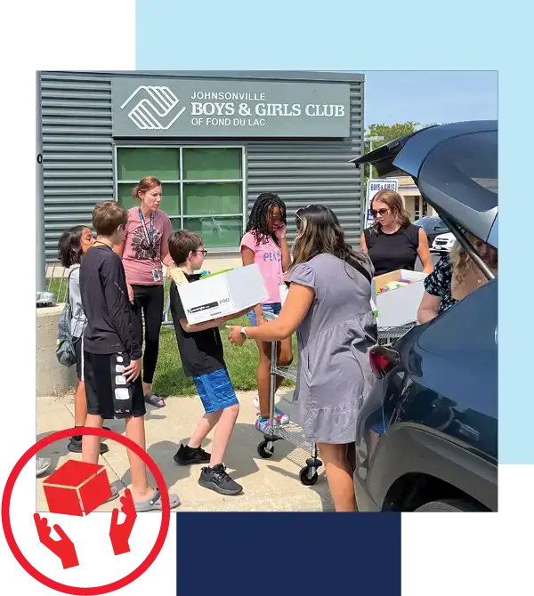 Give where you live image of Holiday Team carrying supplies into Boys and Girls club