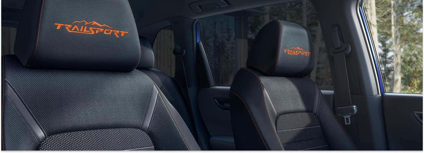 Interior view of a 2026 Honda CR-V TrailSport showing black seats with orange embroidered headrests.