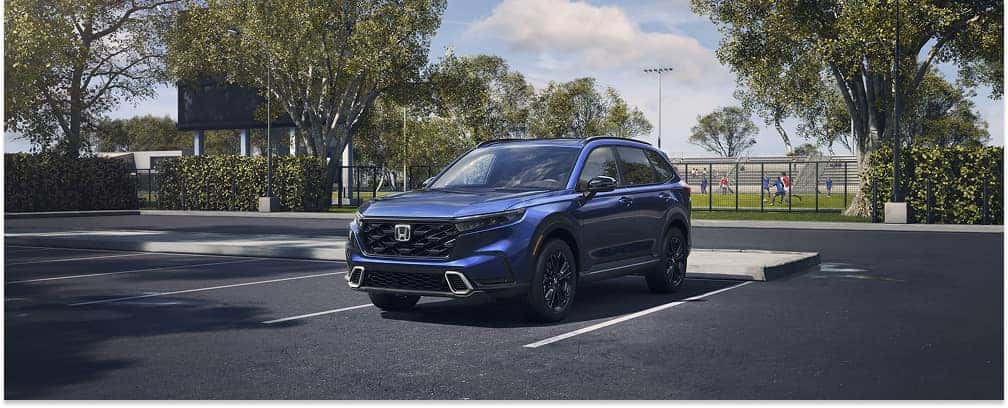 Blue 2026 Honda CR-V SUV parked in an outdoor lot in front three-quarter view.