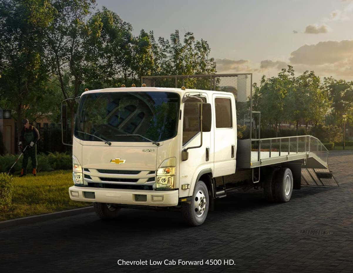 Front three-quarter view of a white Chevrolet Low Cab Forward landscaping truck parked.
