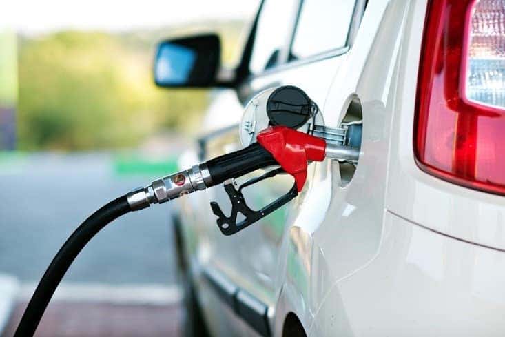 A gas pump fueling up a vehicle.