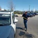 Nigel Treat washing a car before a guest's appointment