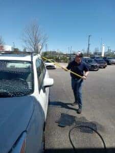 Nigel Treat washing a car before a guest's appointment