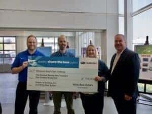 Knutson and Medvec presenting check to Teen Challenge