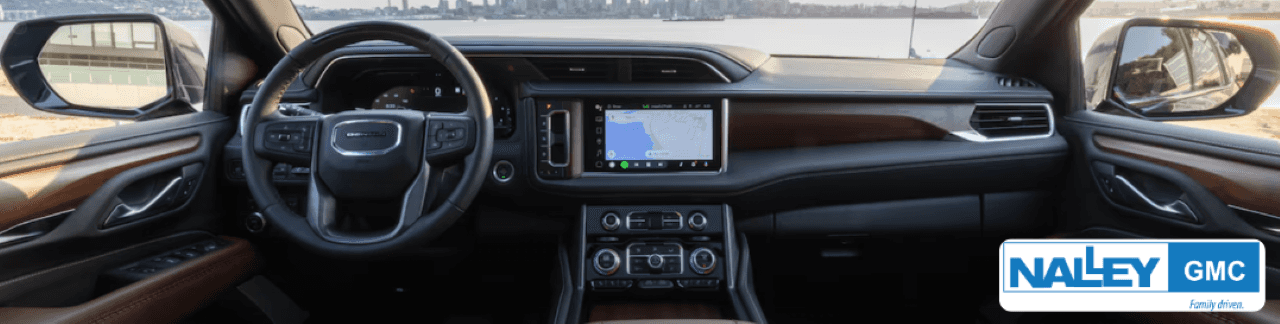 A photo of an interior view showcasing the advanced technology features of a GMC Yukon Denali SUV.