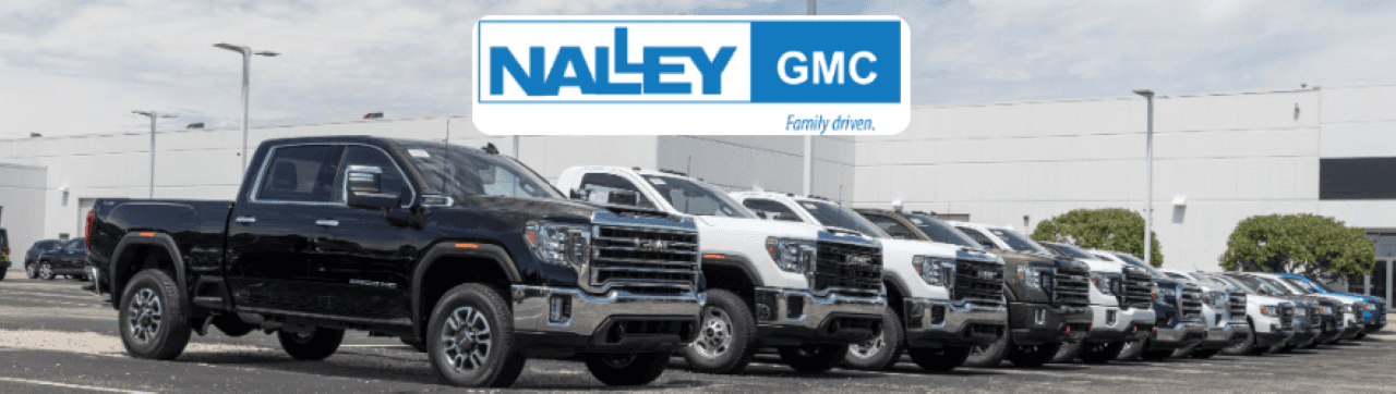 Nalley GMC dealership exterior featuring a lineup of used cars and fuel-efficient GMC vehicles in Brunswick, GA.