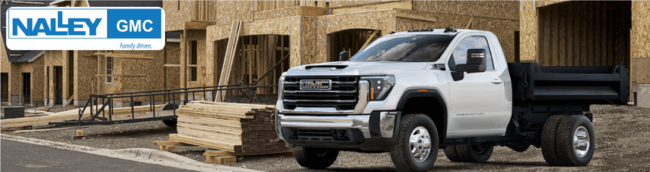An exterior shot of the Nalley GMC dealership in Brunswick, GA, showcases GMC 3500 HD trucks for sale.