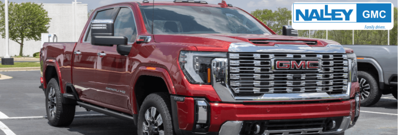 Customers browsing GMC 2500 trucks for sale at Nalley GMC in Brunswick, GA, with expert assistance from staff.