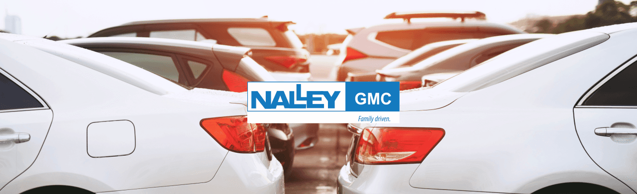 Exterior view of Nalley GMC dealership in Brunswick, GA, showcasing a lineup of high-quality used cars ready for sale.