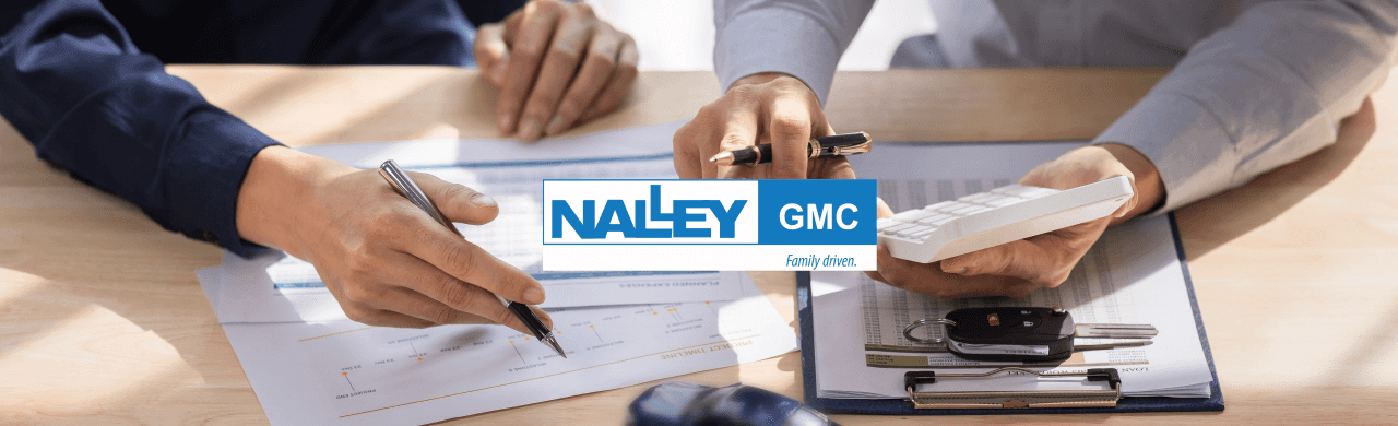 Friendly Nalley GMC salesperson assisting a customer in choosing the perfect pre-owned vehicle in Brunswick, GA.