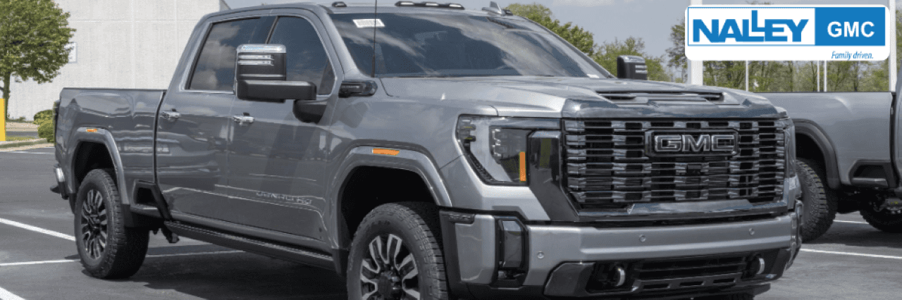 A satisfied customer driving off in a pre-owned car purchased from Nalley GMC, your trusted used dealership near me.