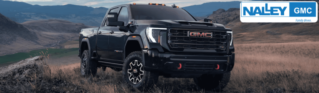Nalley GMC dealership in Brunswick, GA, showcasing a lineup of GMC 2500 trucks for sale.