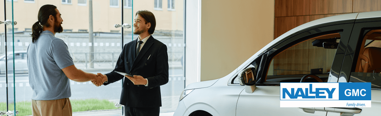 Friendly staff assisting customers at Nalley GMC dealership in Brunswick.