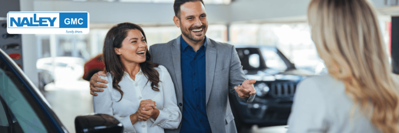 Nalley GMC sales team assisting a customer with car buying at the Brunswick, GA dealership.