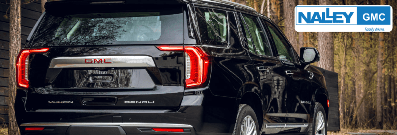 The 2023 GMC Yukon for sale is parked at Nalley GMC with a scenic Brunswick background.