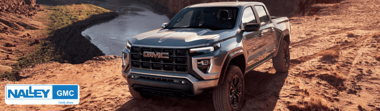 Nalley Buick GMC dealership in Brunswick, GA, with a lineup of GMC trucks ready for sale.