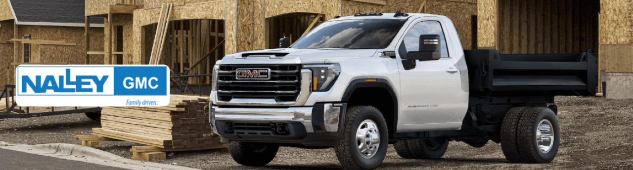 The GMC 3500 truck is parked on a scenic road in Brunswick, GA, showcasing its rugged design and heavy-duty capabilities.