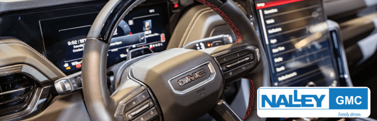 Interior of used GMC Yukon with leather seating and advanced infotainment system for sale near Jacksonville, FL.