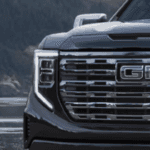 2025 GMC Sierra parked at Nalley GMC in Brunswick, GA, highlighting bold front grille and modern truck design.