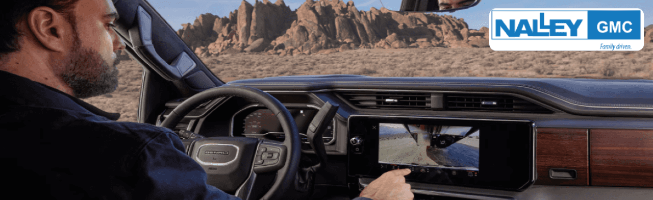 Customer test-driving a GMC pickup truck from the Nalley Brunswick GMC dealership lot.