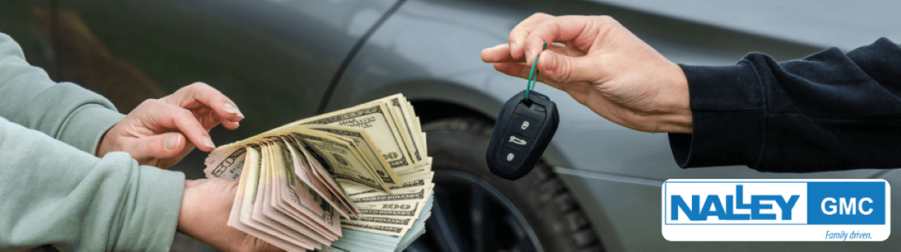 Customer reviewing a Max Allowance cash offer at Nalley GMC Brunswick near Charleston, SC.